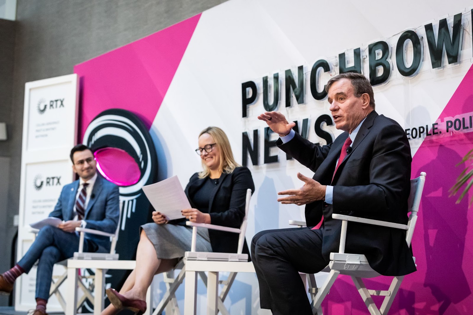 Sen. Mark Warner speaking at a Punchbowl News event with Anna Palmer and Andrew Desiderio.