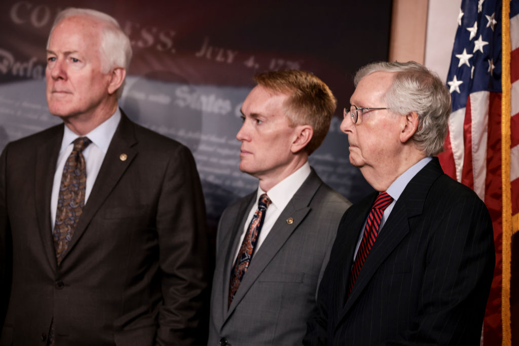 Sens. John Cornyn, James Lankford and Mitch McConnell stand together at a press conference.