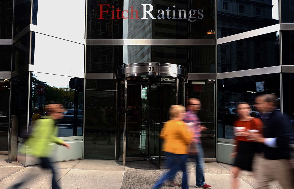 People walk in front of the Fitch Ratings building