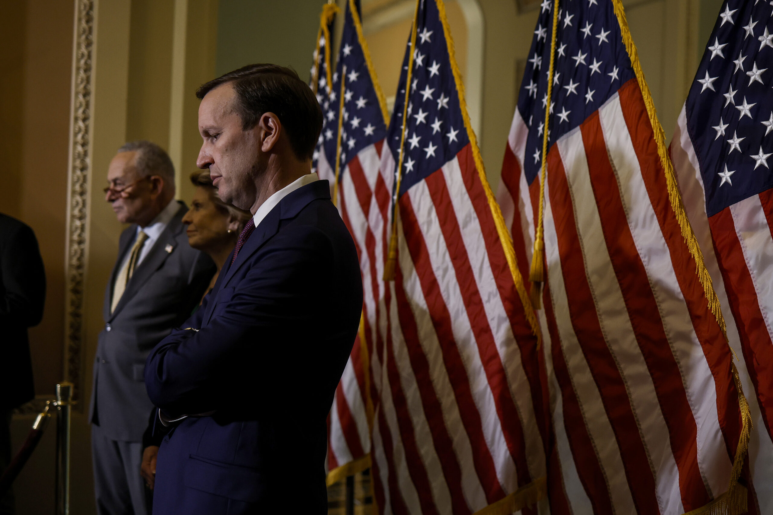Sen. Chris Murphy (D-CT) listens at a news conference after a policy luncheon with Senate Democrats next to Senate Majority Leader Chuck Schumer