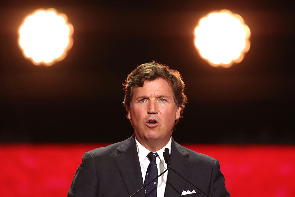 As Rep. Randy Fine was laying into Tucker Carlson during a speech to fellow Jewish Republicans on Saturday, a group of students stood in front of the stage holding signs that read “TUCKER IS NOT MAGA.”